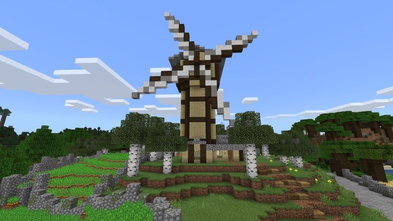 A farm plot, a stone tower, and a wooden bridge in a Minecraft landscape